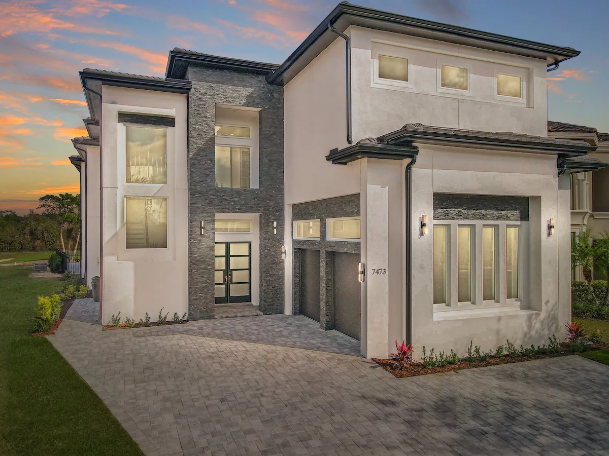A large private Orlando vacation home with a resort-style pool at sunset.