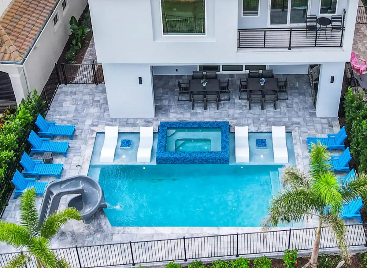A bright poolside view of a large Orlando vacation home.